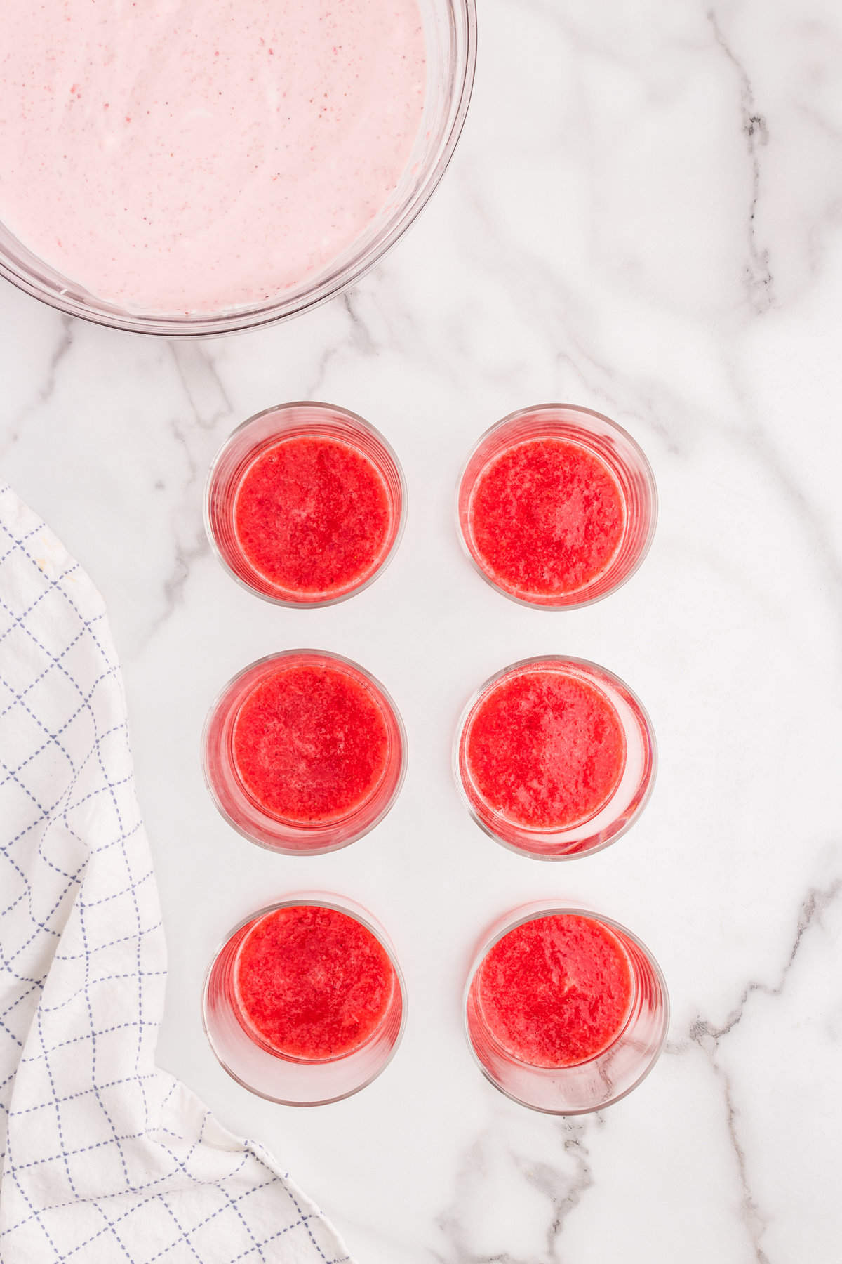 Poured strawberry puree in small glass for Strawberry Mousse