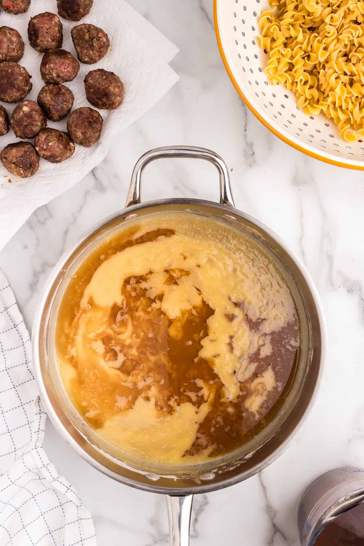 Ingredients for Swedish Meatball Casserole gracy in stovetop skillet