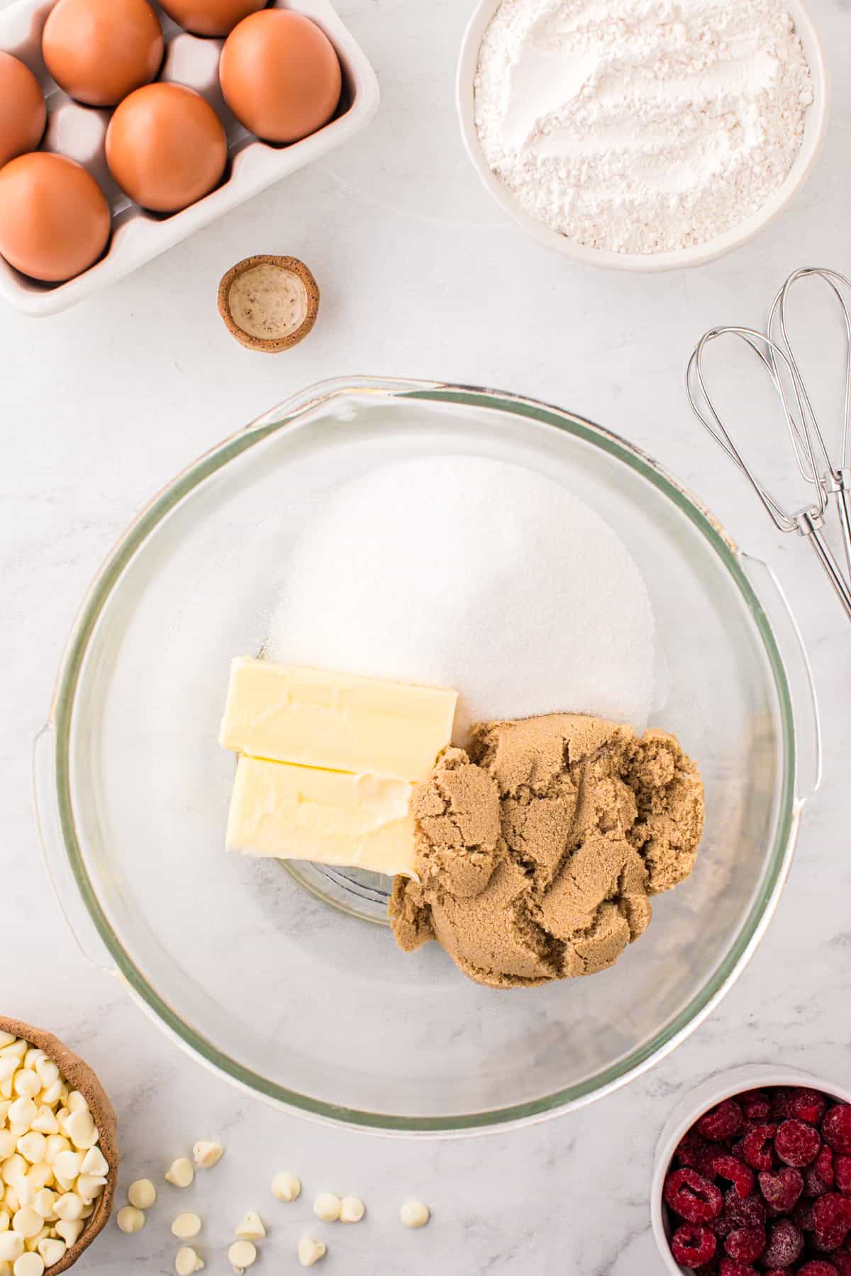 Sugars and butter in glass mixing bowl for White Chocolate Raspberry Cookies