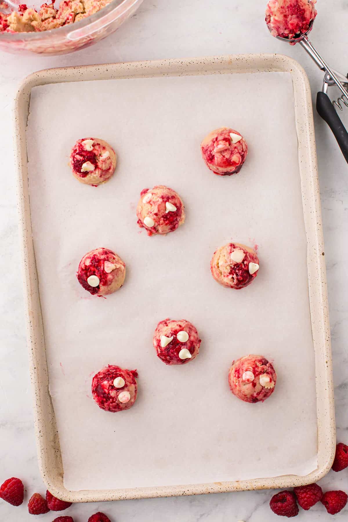 White Chocolate Raspberry Cookies on parchment lined cookie sheet prior to baking