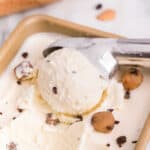 Closeup square image of Cookie Dough Ice Cream being scooped from pan