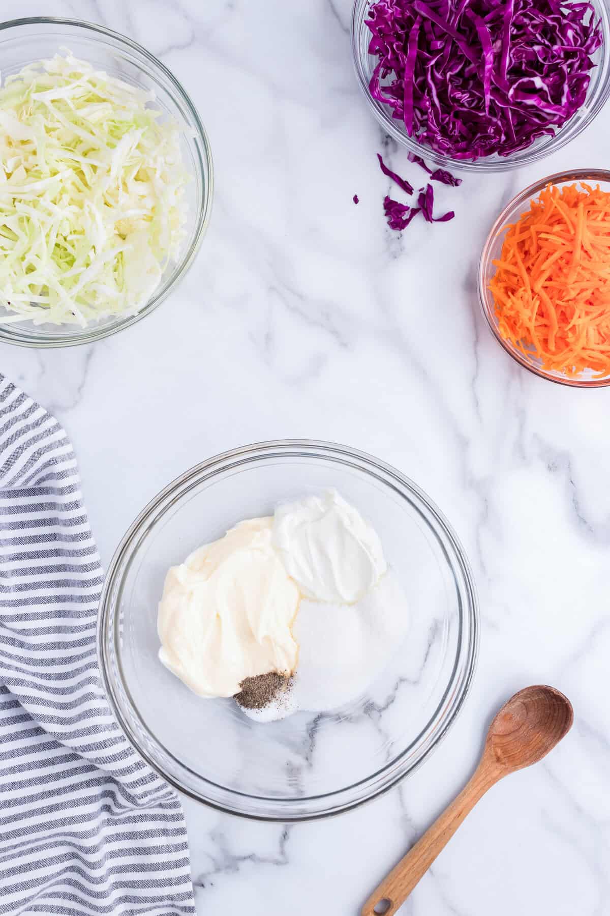 Creamy Coleslaw dressing ingredients in glass mixing bowl