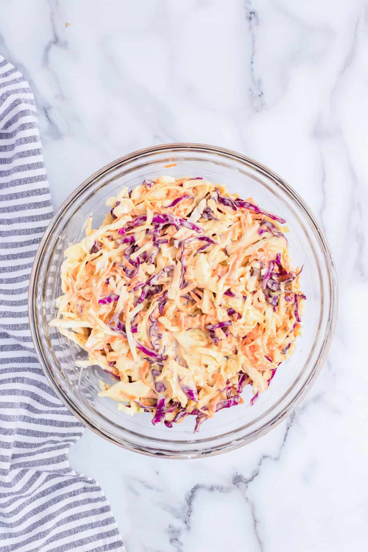 Folded Creamy Coleslaw ingredients in glass mixing bowl
