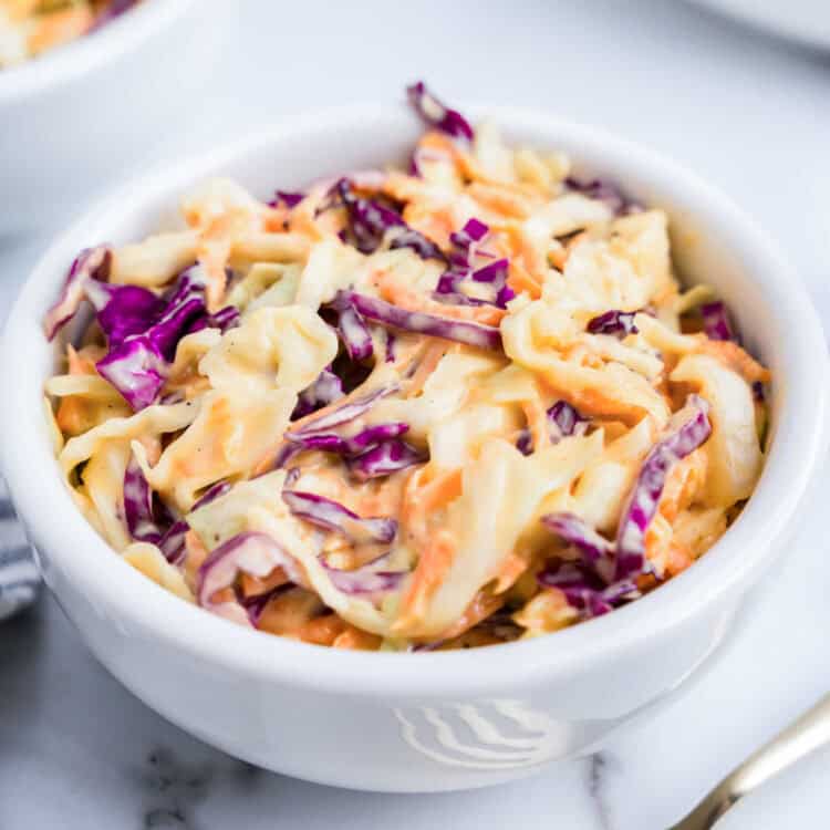 Closeup square image of Creamy Coleslaw in white bowl