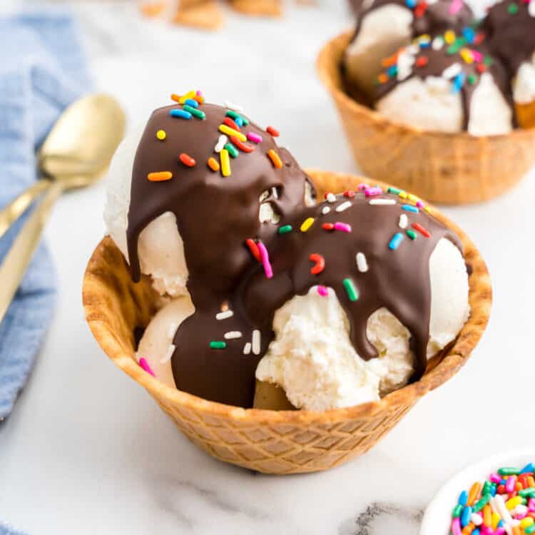 Homemade Magic Shell topped with sprinkles over vanilla ice cream