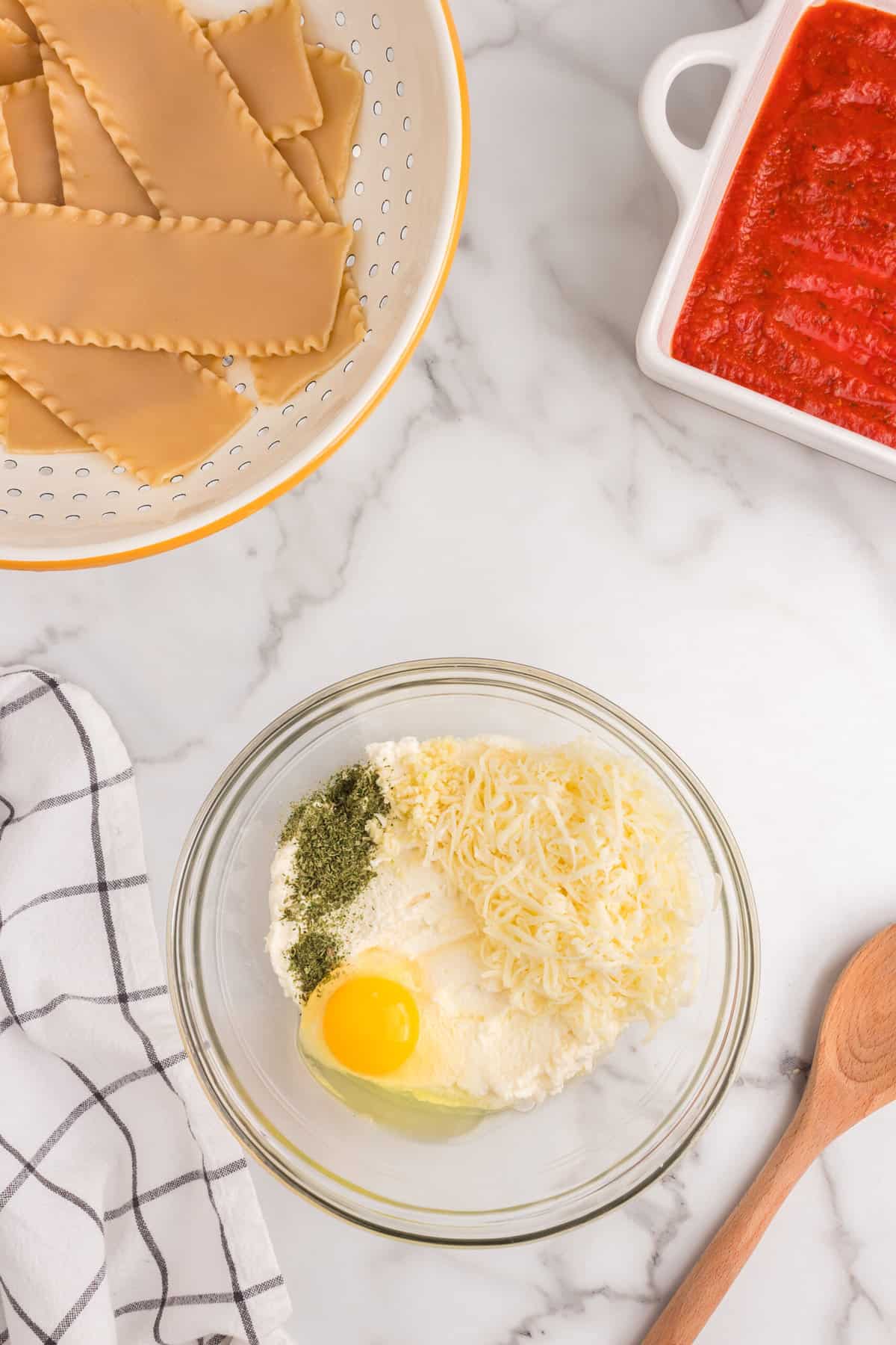 Cheese ingredients for Lasagna Roll Ups in mixing bowl