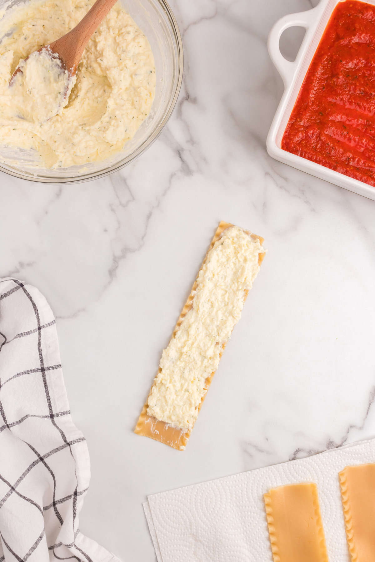 Cheese mixture spread on cooked lasagna noodle for Lasagna Roll Ups recipe