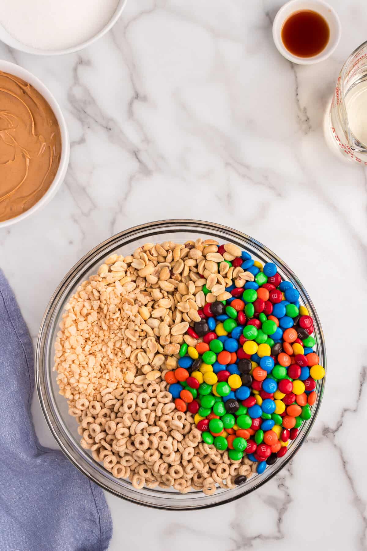 In a large bowl put together the cereals and M&M's. Set aside.