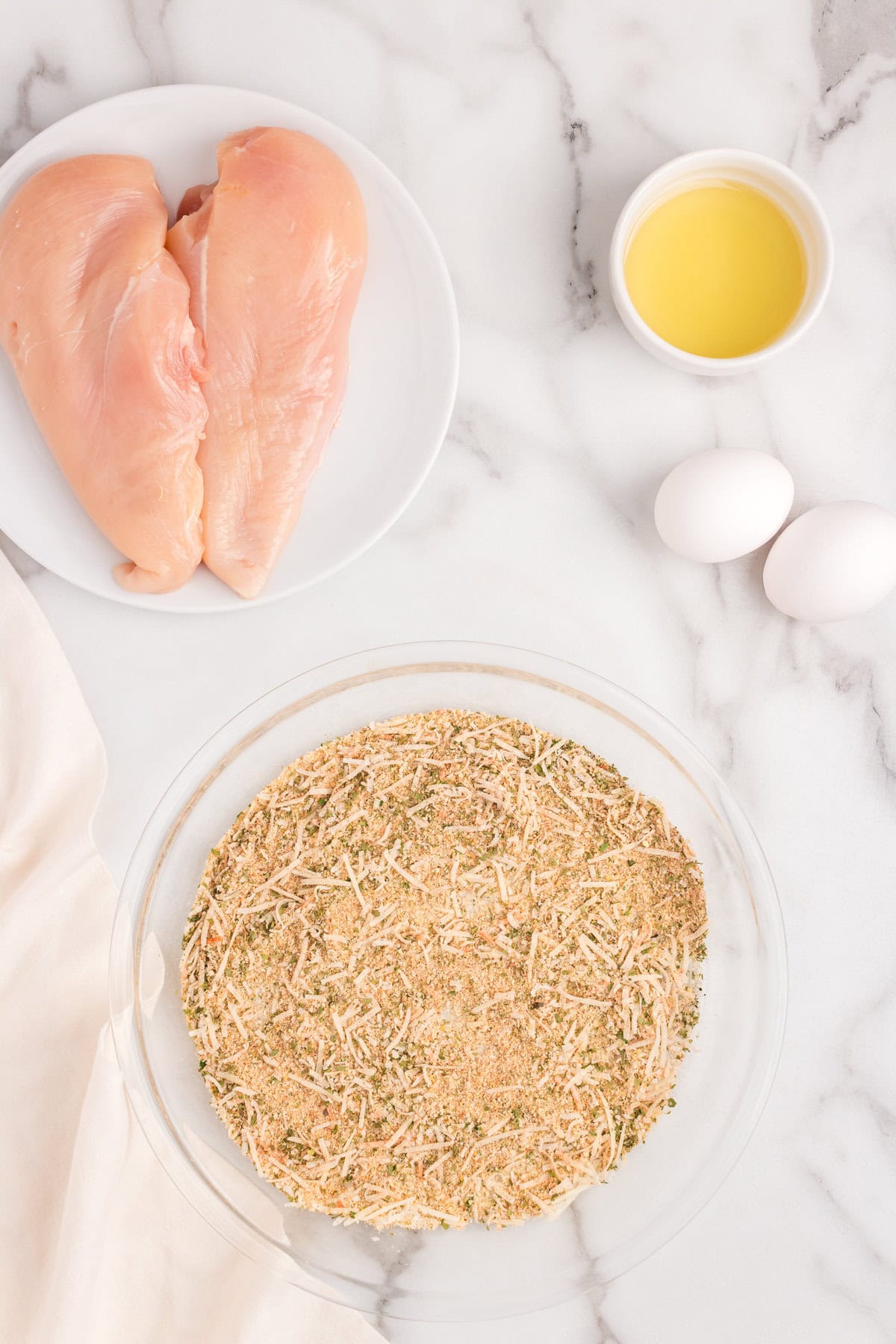 Combined seasoning ingredients in shallow glass mixing bowl for Parmesan Crusted Chicken recipe