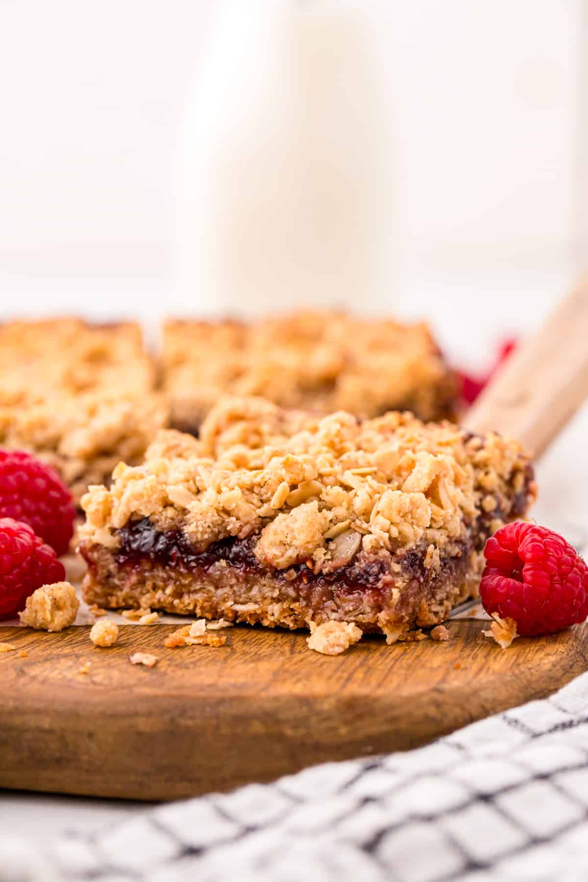 Raspberry Crumble Bars cut into squares on cutting board