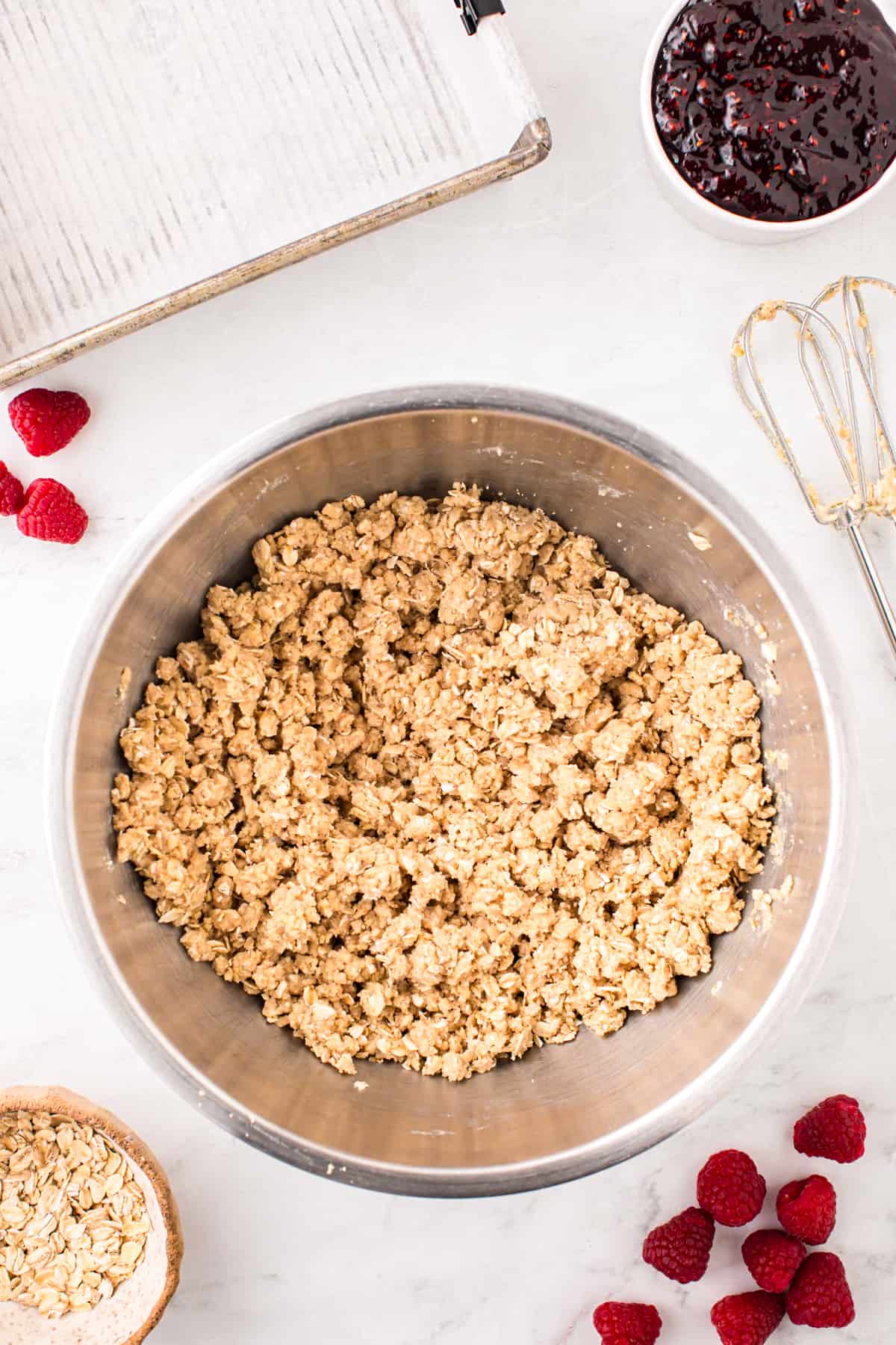 Combined dry ingredients for Raspberry Crumble Bars with butter in mixer