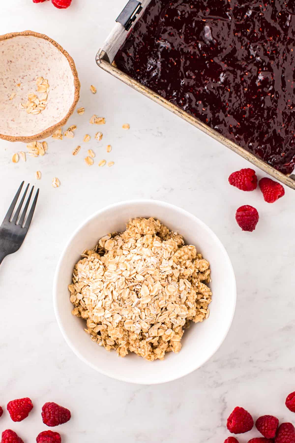 Preparing topping for Raspberry Crumble Bars in small mixing bowl
