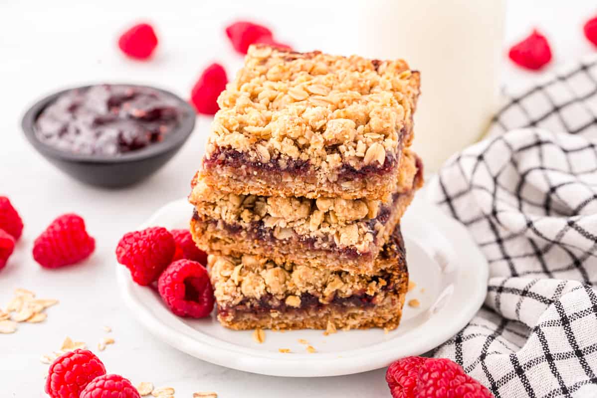 Raspberry Oat Crumble Bars cut into squares arranged on plate