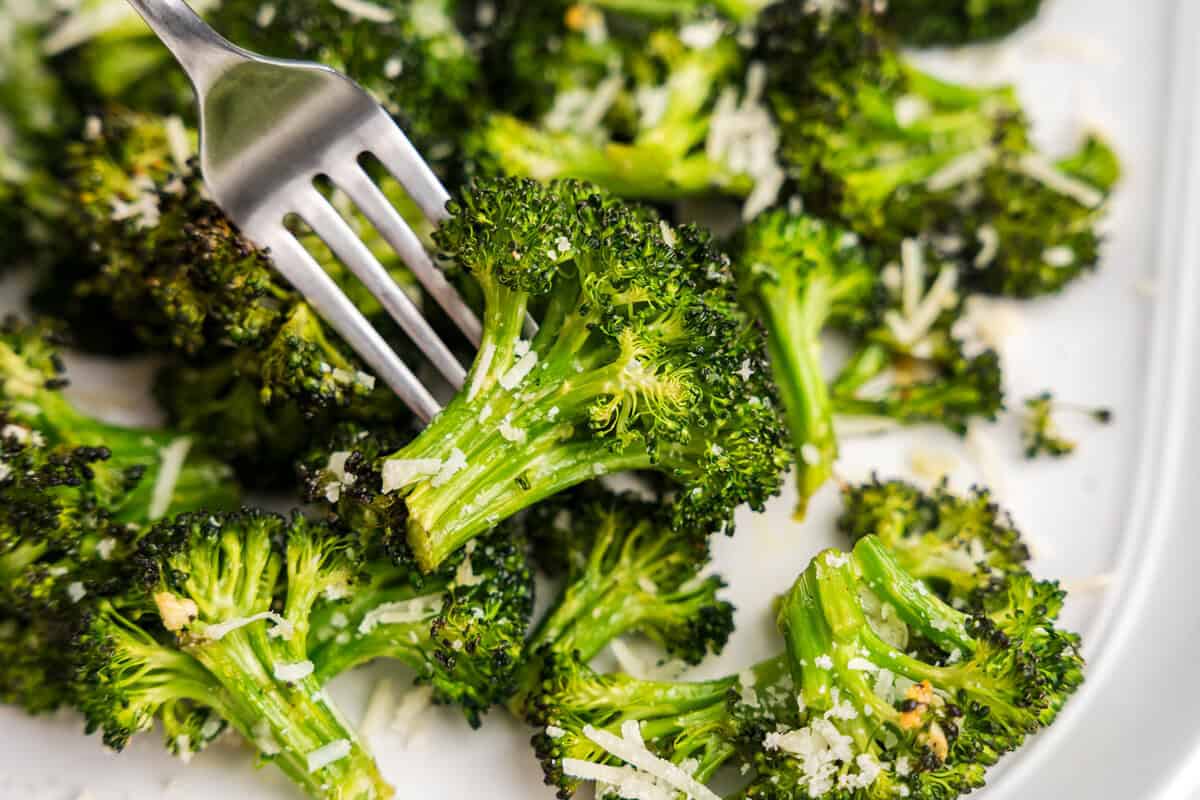 Roasted Broccoli on white plate with fork