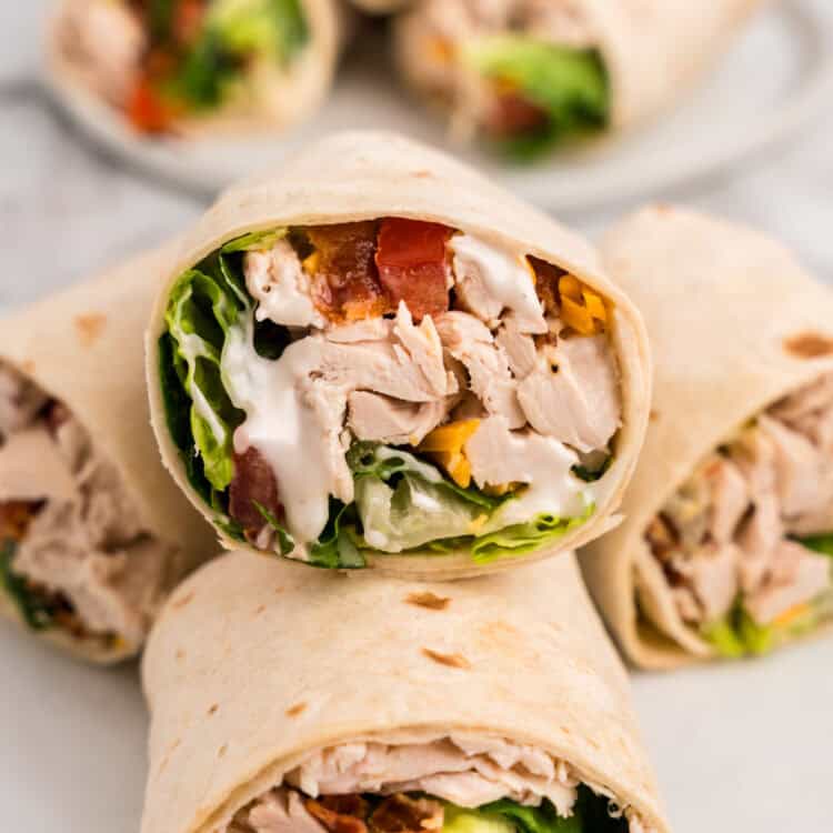 Chicken Bacon Ranch Wraps sliced in half arranged on plate