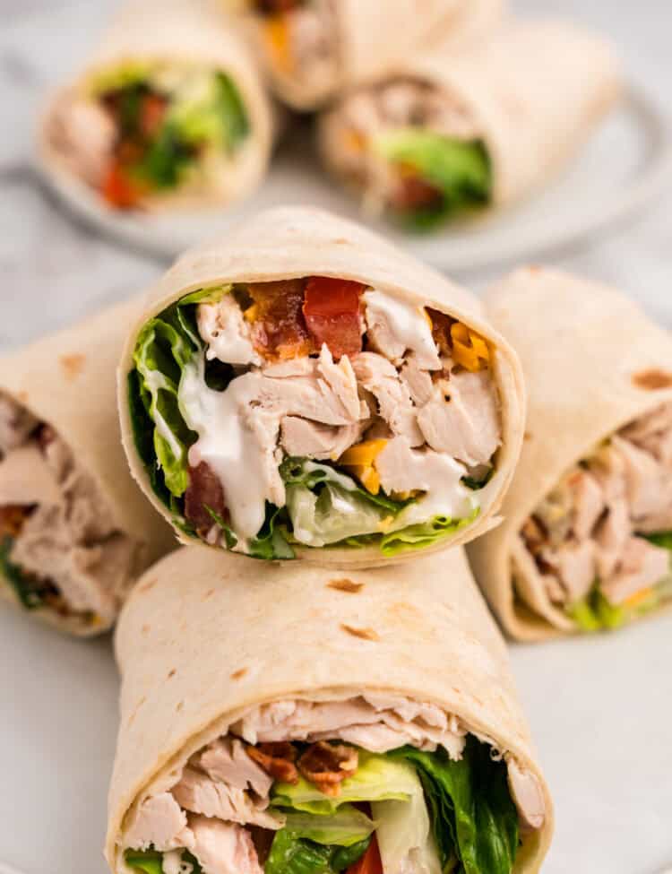 Chicken Bacon Ranch Wraps sliced in half arranged on plate