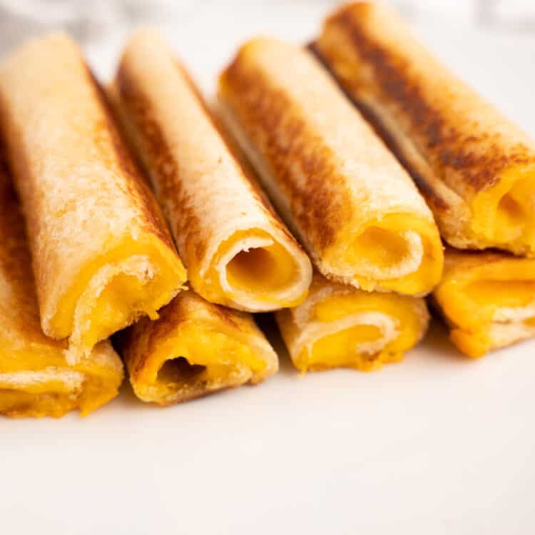 Stack of completed grilled cheese roll ups.