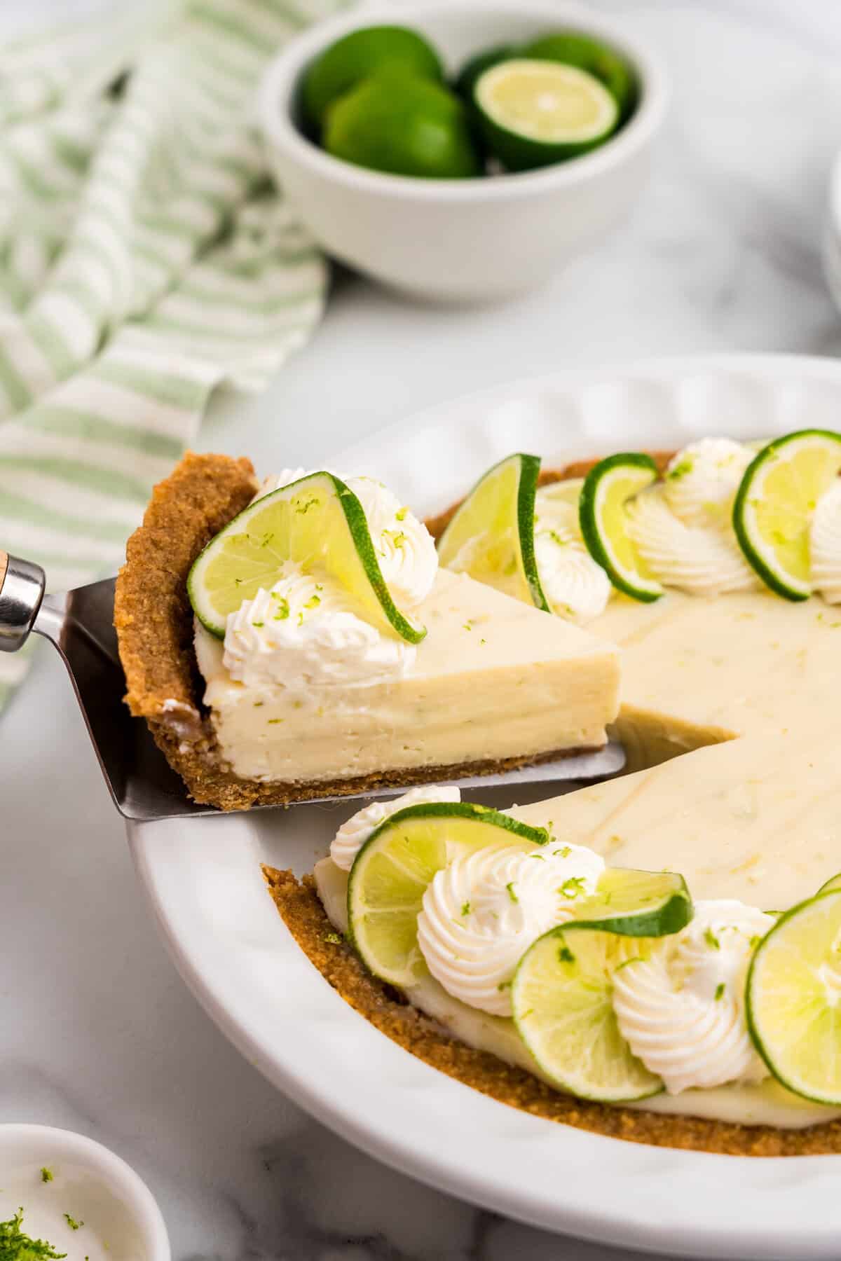 Key Lime Pie slice being pulled from pie plate