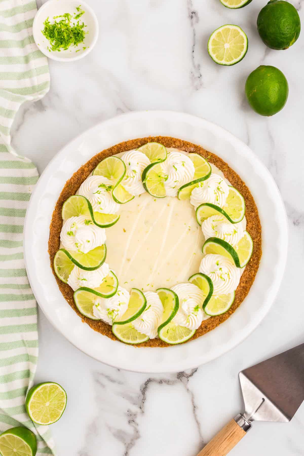 Key Lime Pie topped with whipped cream, fresh lime slices and lime zet