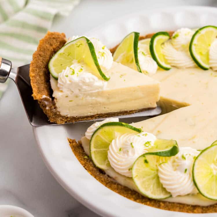 Key Lime Pie with slice being pulled from pie plate