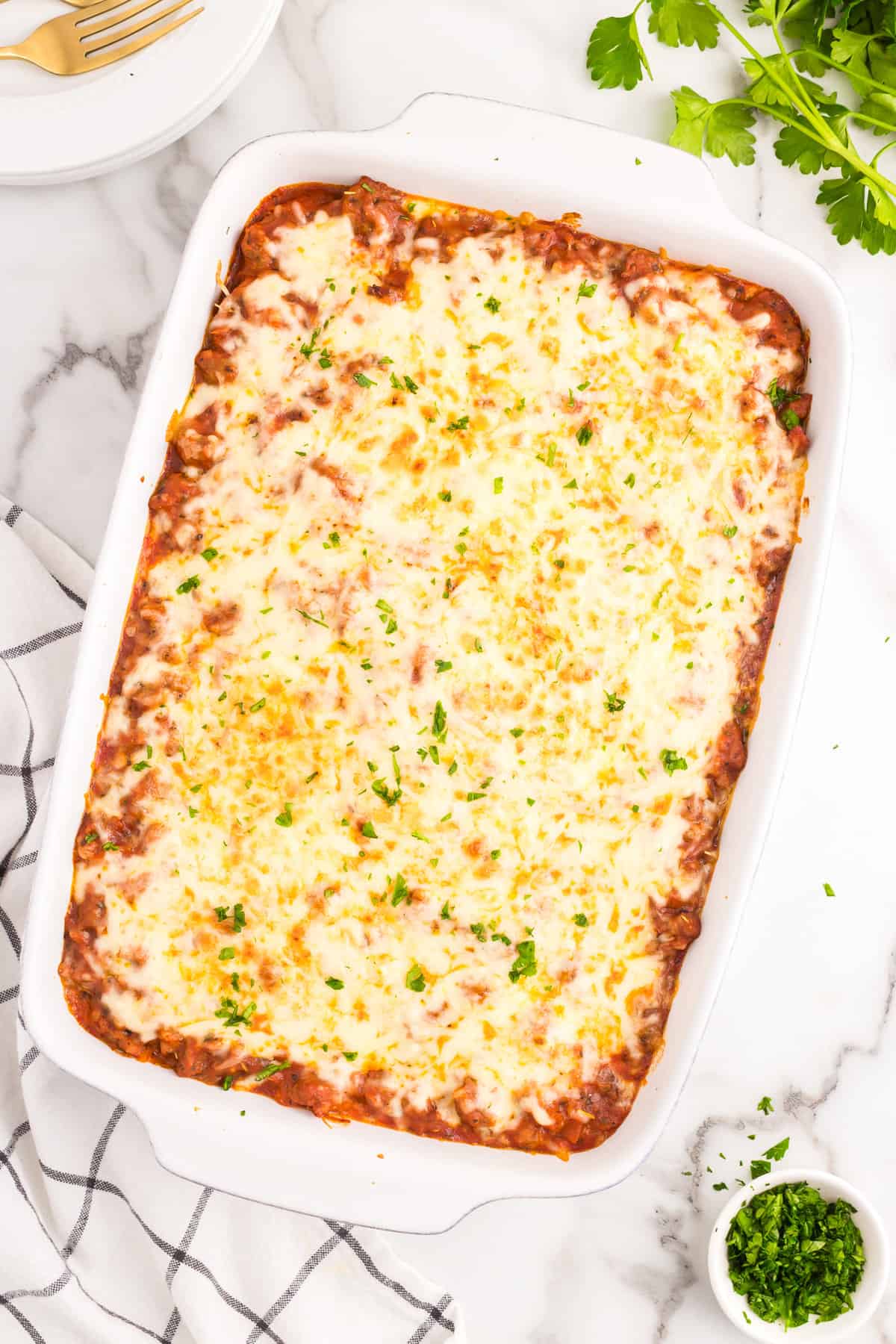 Million Dollar Spaghetti just out of the oven in 9x13 baking dish with the cheese baked to a golden brown