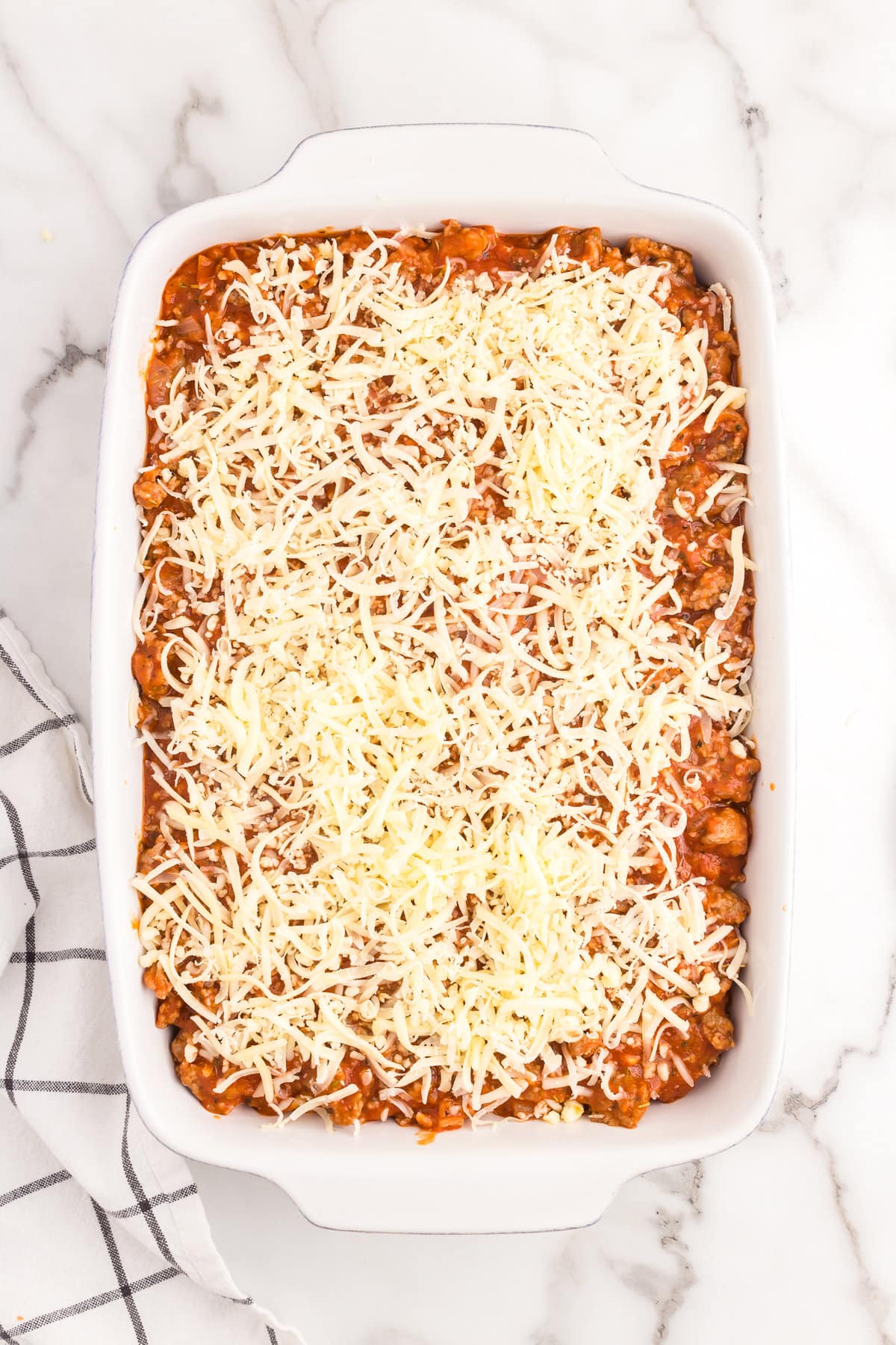 Adding shredded cheese layer to Million Dollar Spaghetti Casserole recipe in 9x13 baking dish