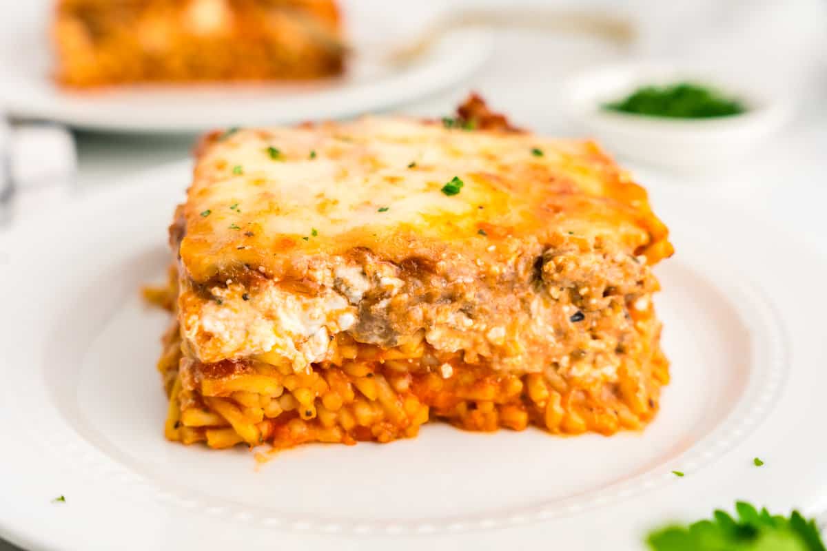Million Dollar Spaghetti Casserole cut into square on dinner plate