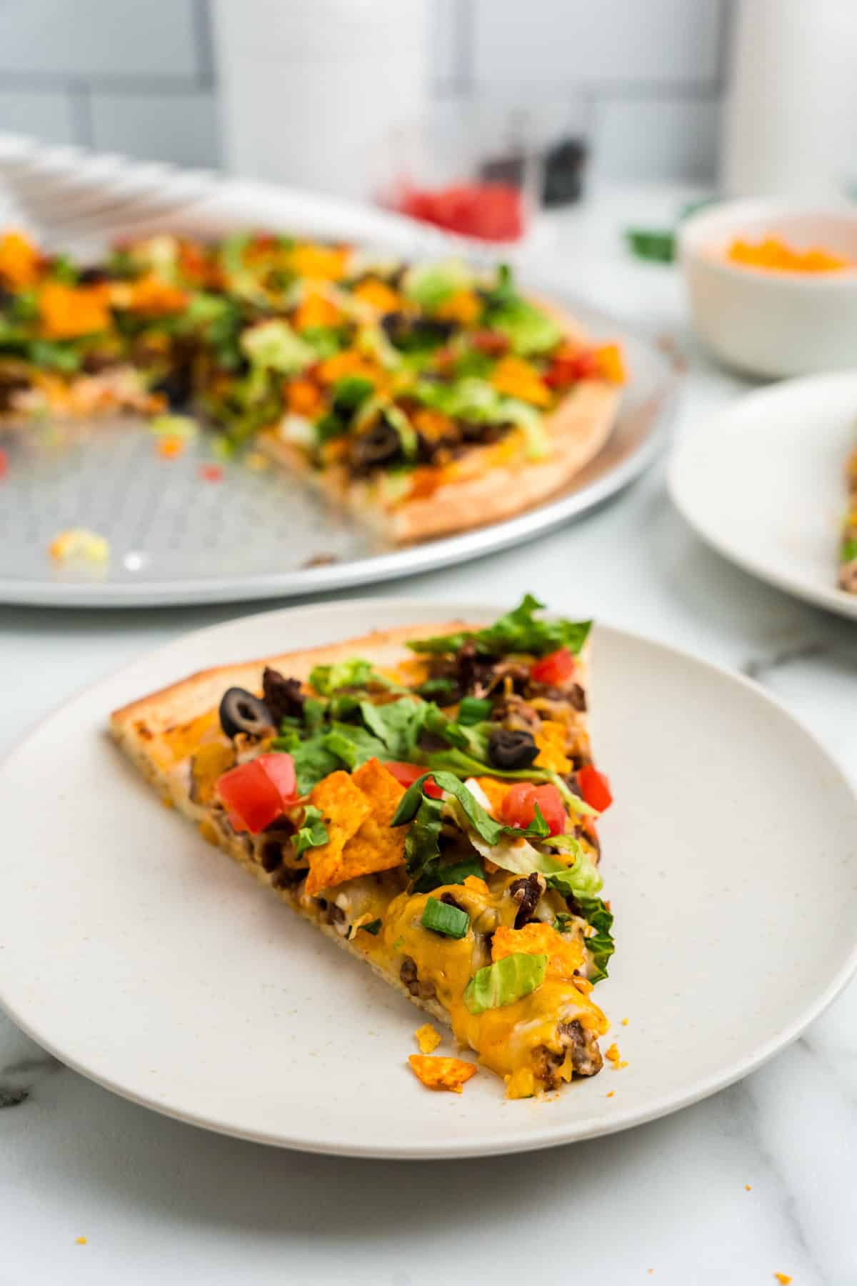 Slice of Taco Pizza on plate ready to enjoy