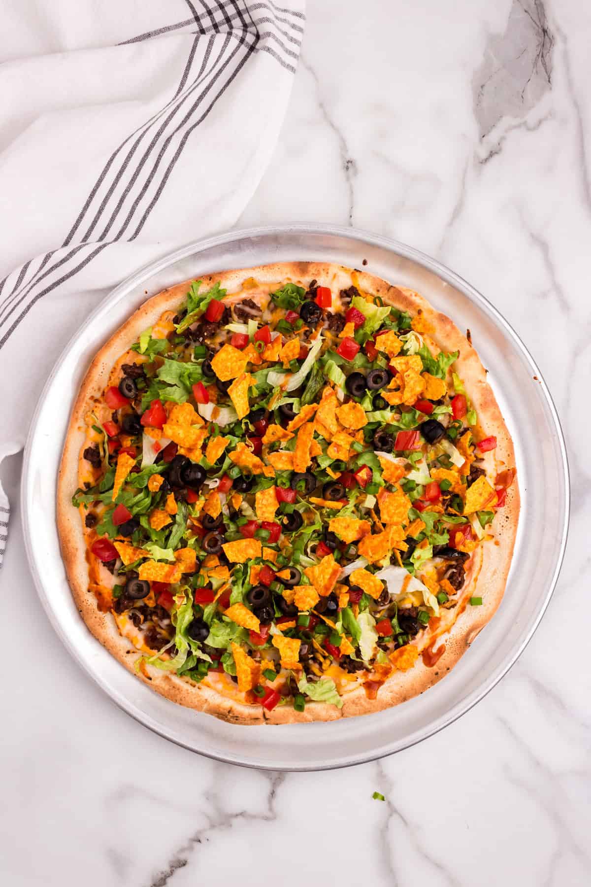 Taco Pizza on pizza tin topped with all the taco fixings