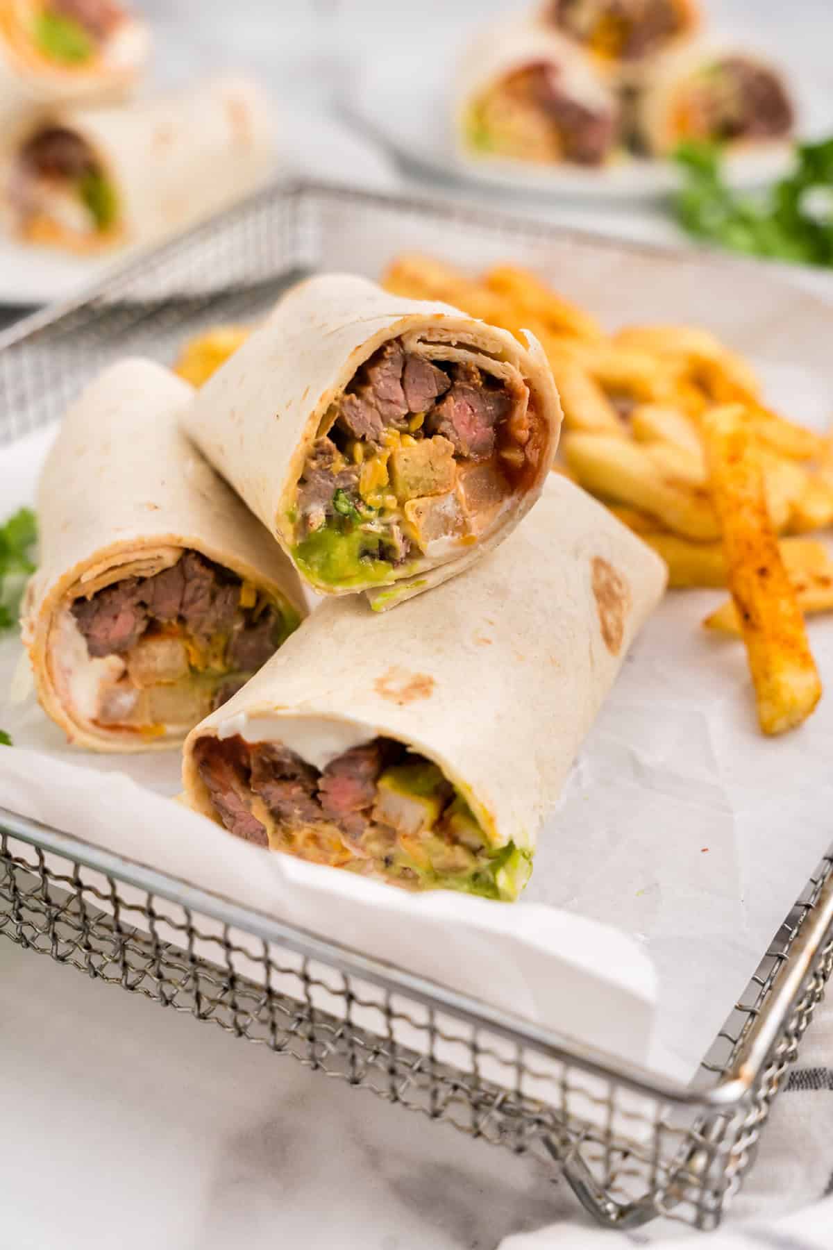 California Burrito sliced open with french fries in parchment-lined serving basket