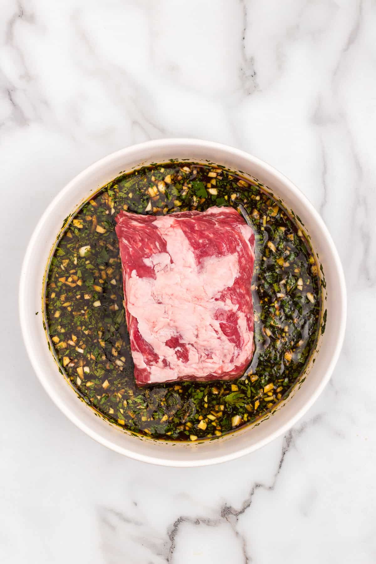 Adding steak to marinade for California Burrito recipe