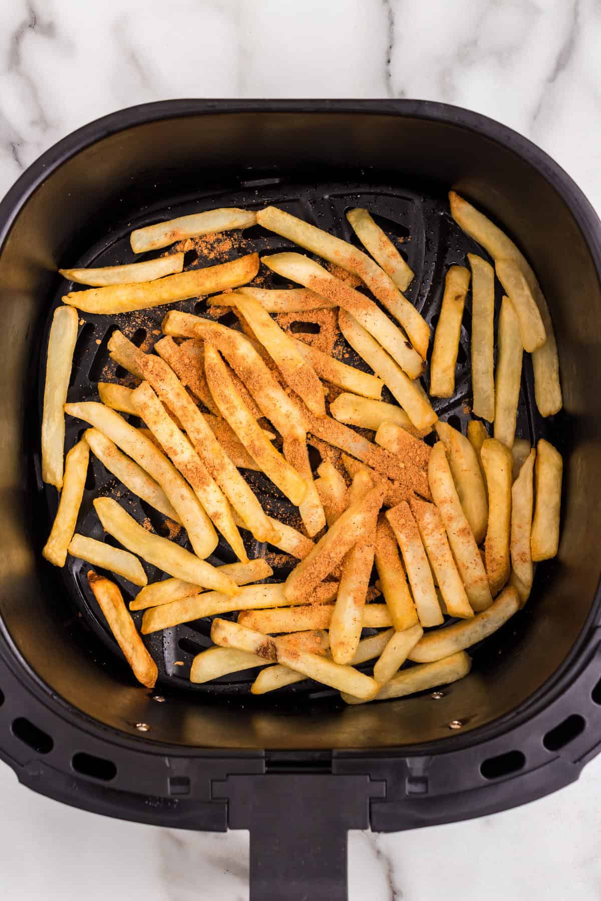 French fries in air fryer tossed with taco seasoning for California Burrito recipe