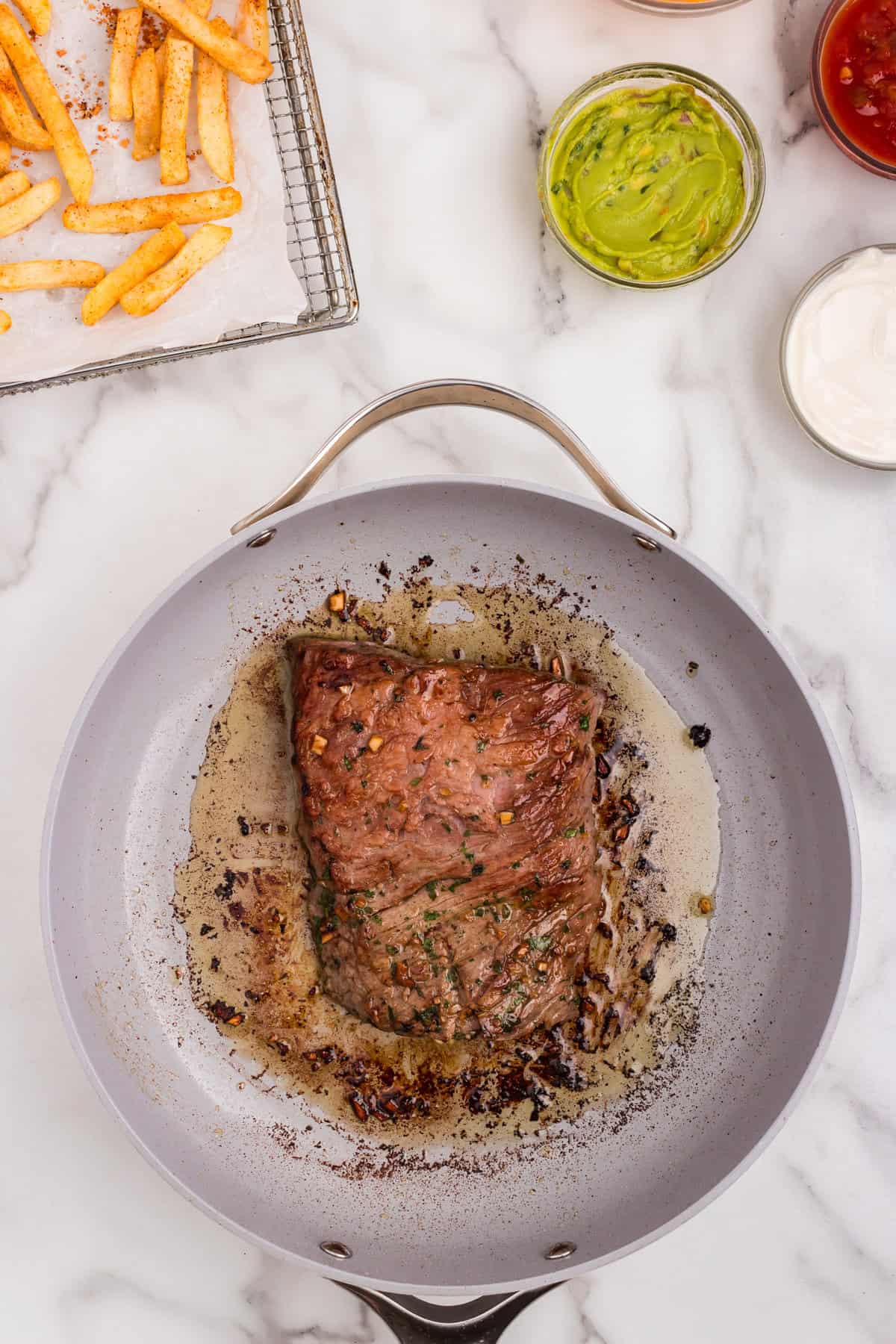 Cooked seasoned steak in skillet for California Burrito recipe