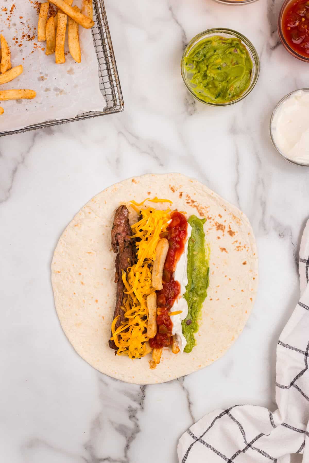 Adding California Burrito ingredients to large tortilla