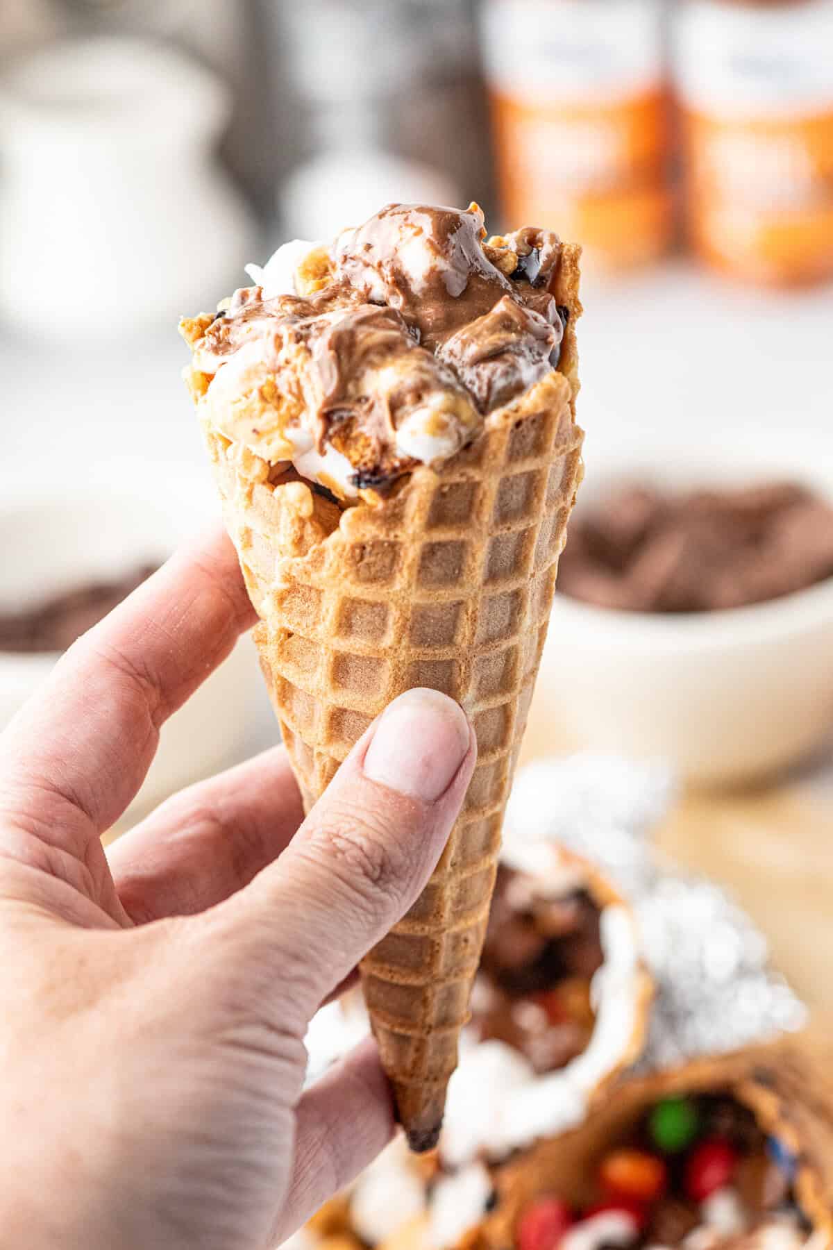 Holding Campfire Cones with one hand