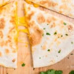 Closeup square image of Cheese Quesadilla cut into triangles