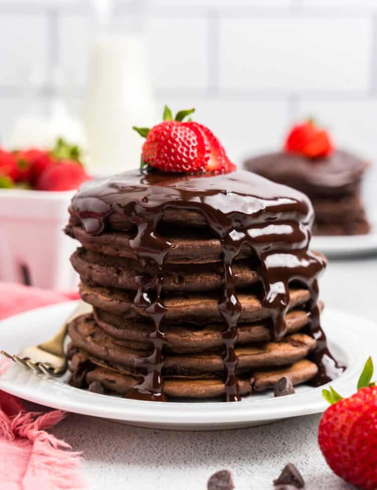 Stack of Chocolate Pancakes with chocolate syrup and a strawberry on top