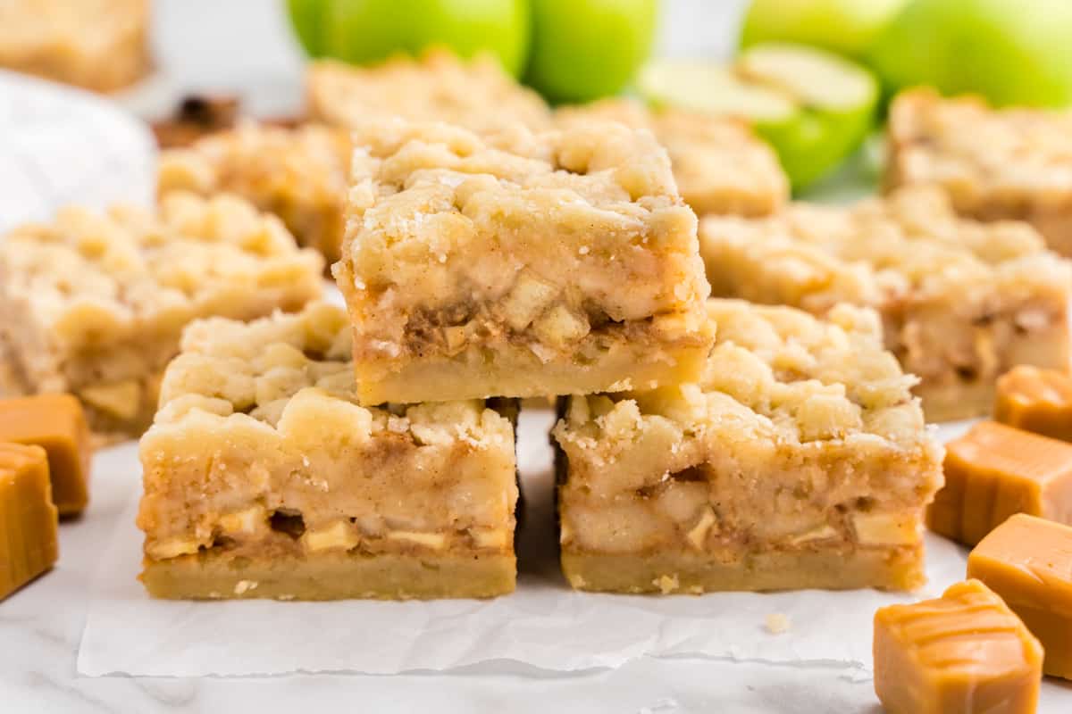 Salted Caramel Apple Butter Bars cut into square on parchment paper lined tray