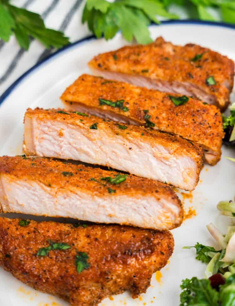 Baked Pork Chops sliced and arranged on dinner plate