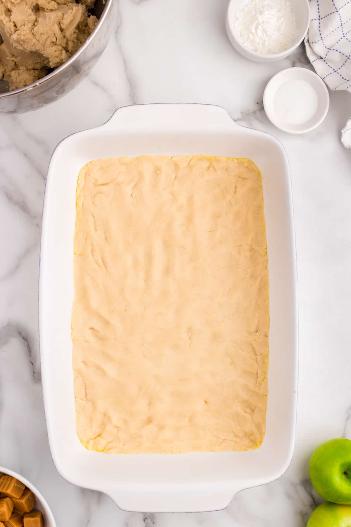 Pressing Creaming together butter and sugars for Salted Caramel Apple Butter Bars crust in 9x13 pan