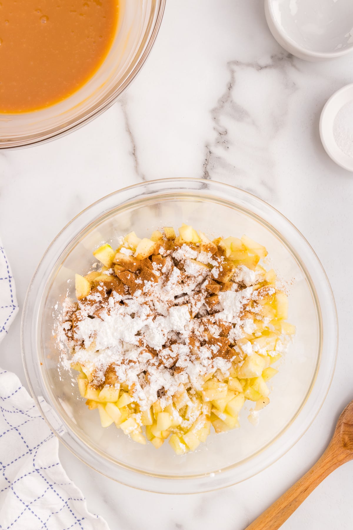 Caramel mixture and diced apples in bowl for Salted Caramel Apple Butter Bars recipe