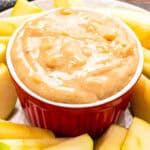 Red ceramic bowl with apple brickle dip
