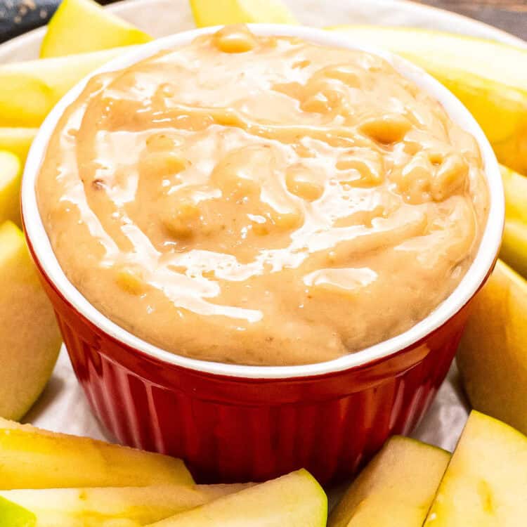 Red ceramic bowl with apple brickle dip
