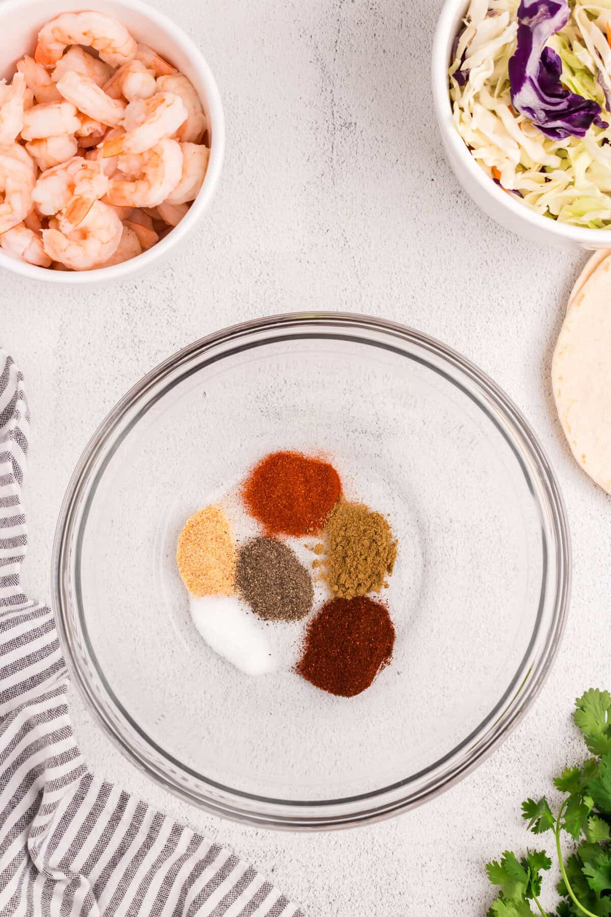 Seasonings for Baja Shrimp Tacos in glass mixing bowl prior to combining