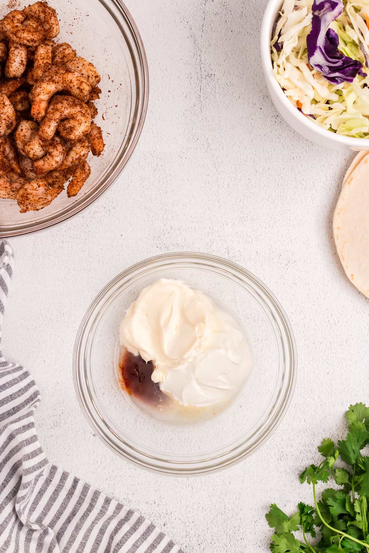 Ingredients for slaw dressing in glass mixing bowl for Baja Shrimp Tacos recipe