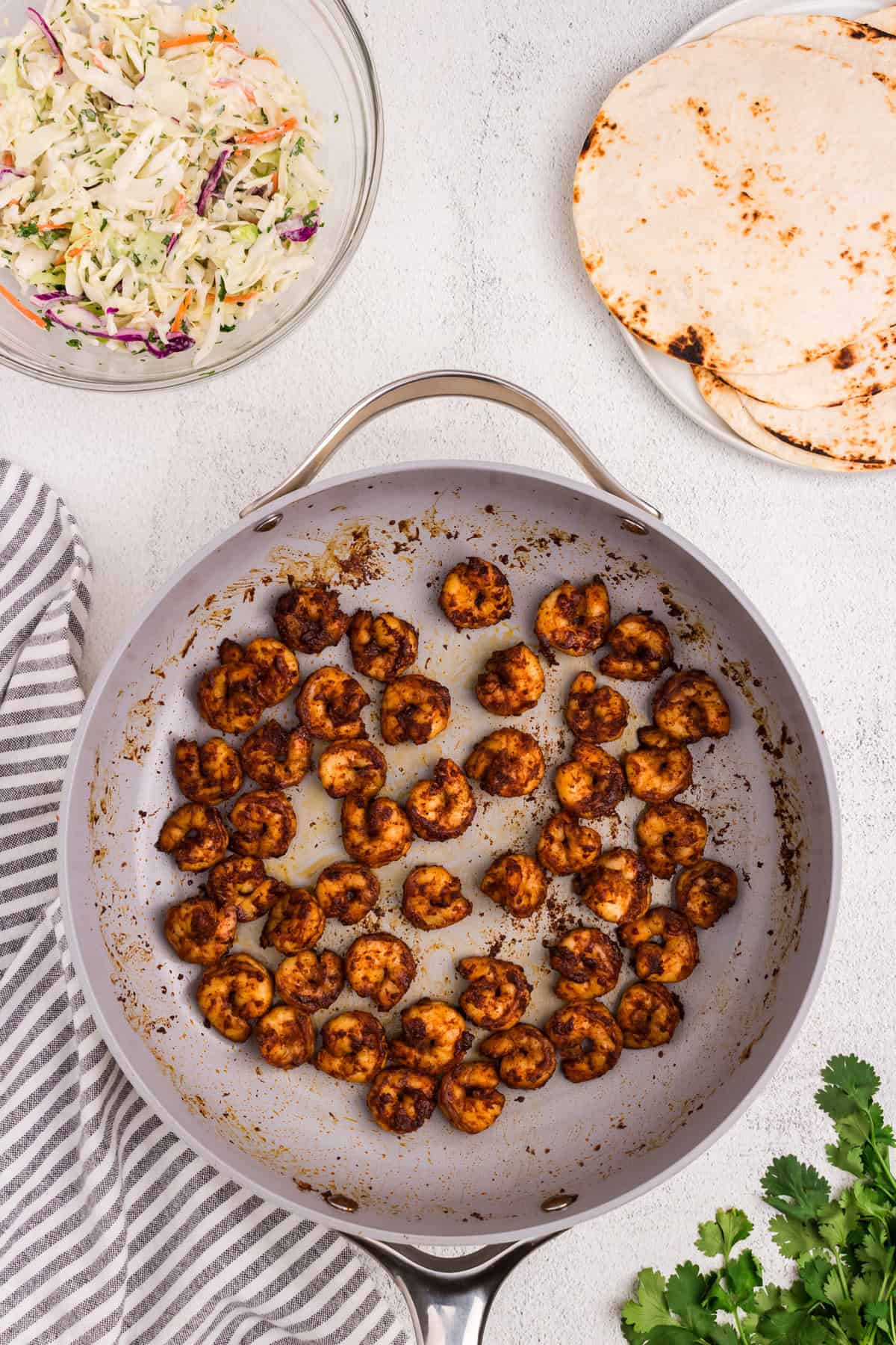 Cooking seasoned shrimp in stovetop skillet for Baja Shrimp Tacos recipe