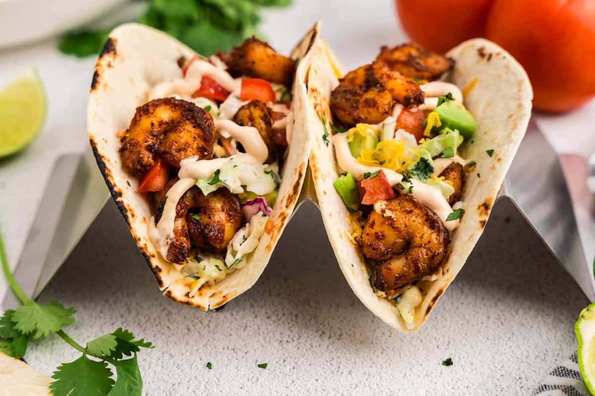Baja Shrimp Tacos with toppings in taco stand