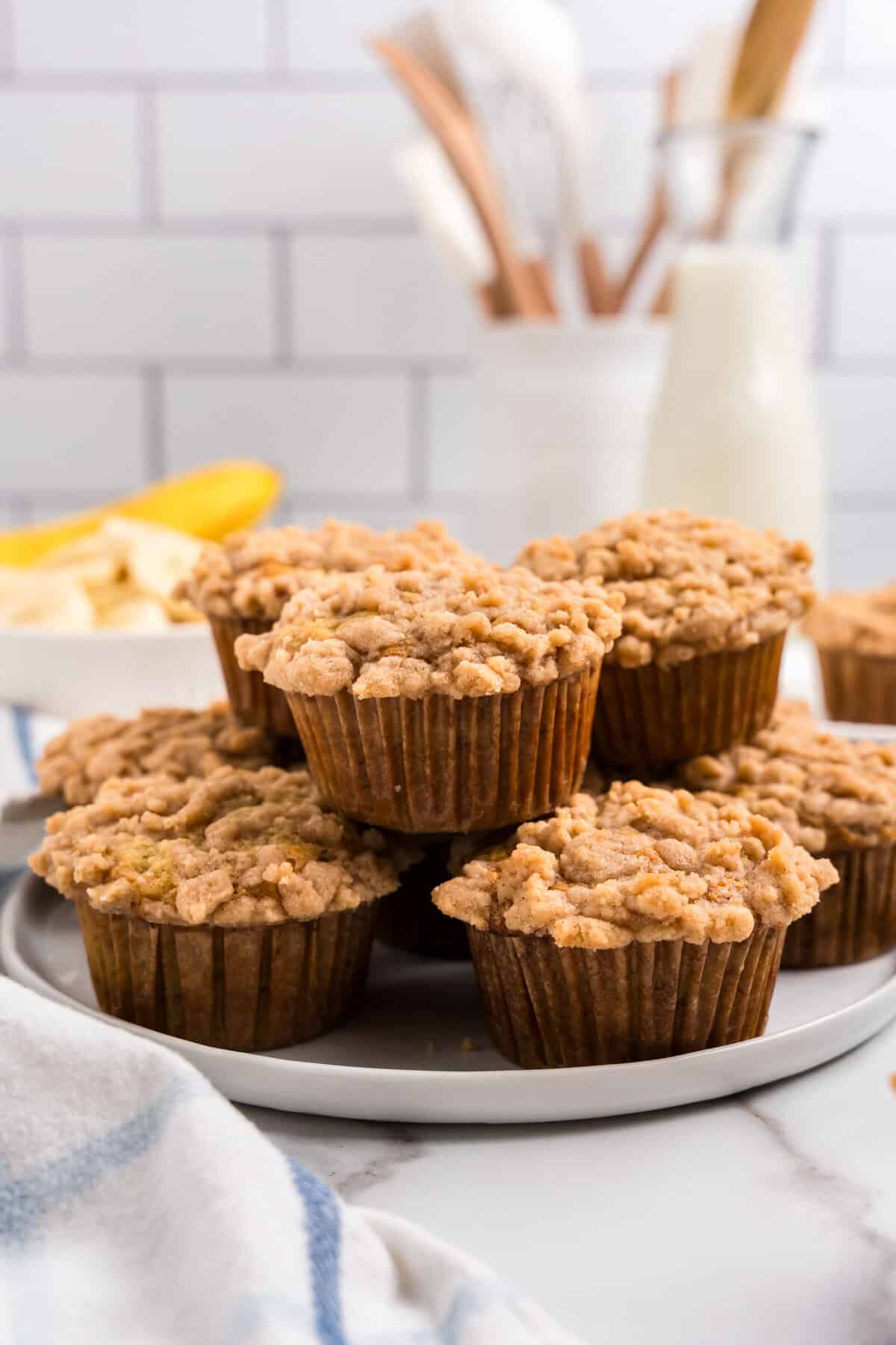 Banana Crumb Muffins stacked on serving plate