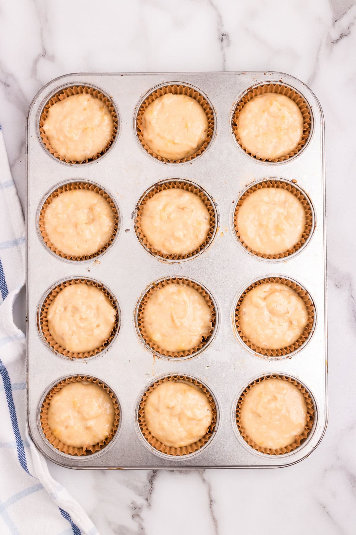Banana Crumb Muffins batter scooped into lined muffin tin