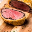 Slice of Beef Wellington on wood cutting board